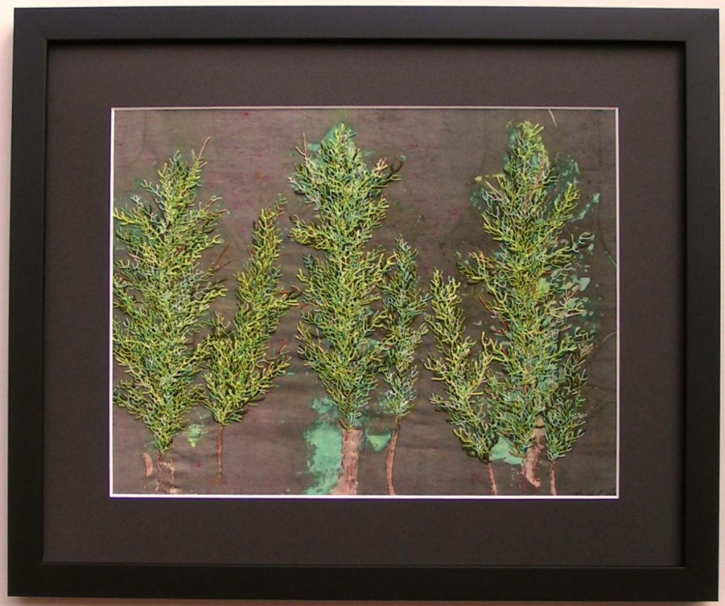 Hand Stitched Artwork by Ruth Lane with screen printed grey background with green cedars in the foreground.